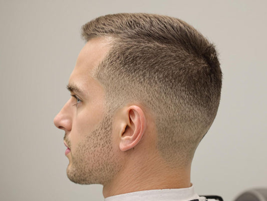 Man with sophisticated haircut in salon chair.
