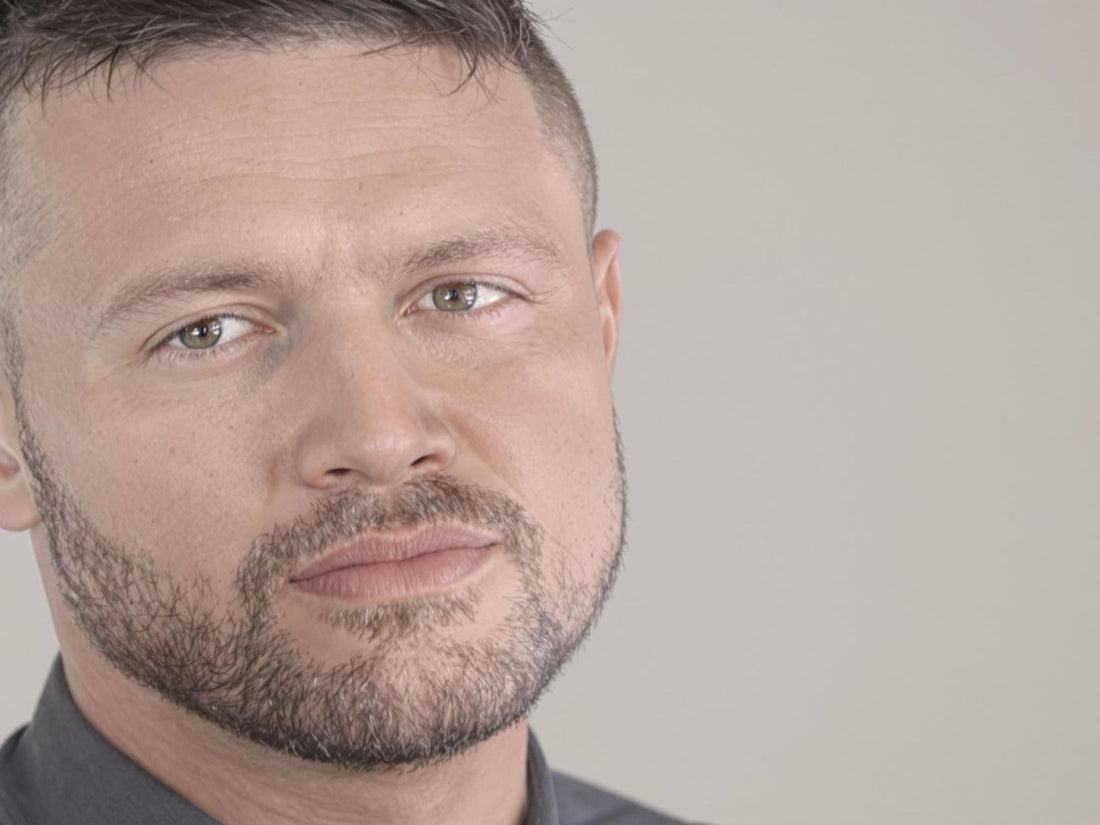 Man with trendy haircut and groomed beard in soft light