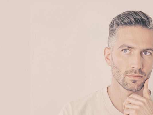 Man with sophisticated haircut, soft lighting.