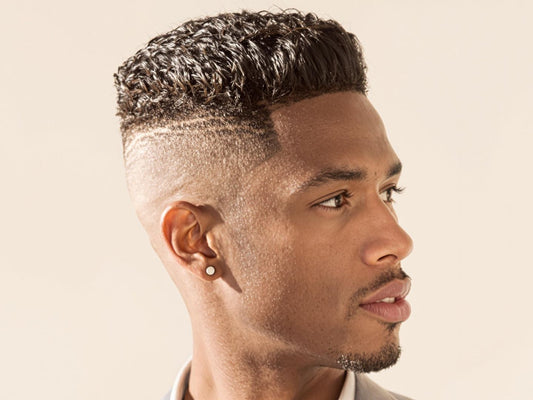 Clean-cut man with modern hairstyle, soft lighting, neutral background.