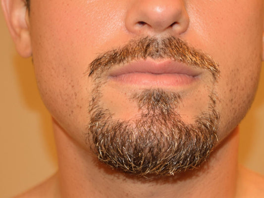 Man with stylish goatee, sharp, modern, sophisticated look.