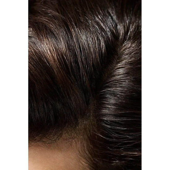 Close-up of hair styled with Oribe Crème For Style, showing enhanced natural texture and shine.