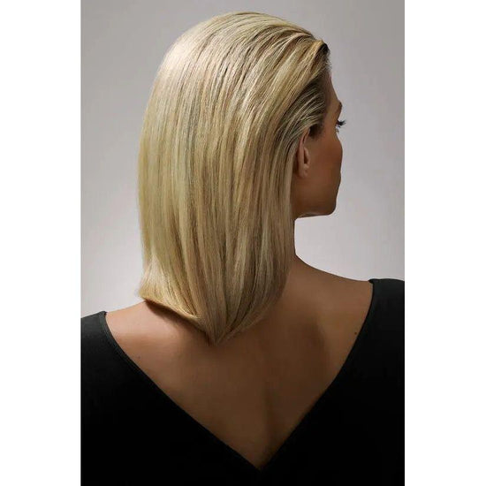 Woman with smooth, shiny blonde hair showcasing the results of Oribe Crème For Style styling cream