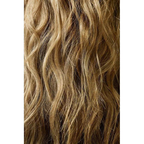 Wavy blonde hair with texture and volume, styled using Oribe Dry Texturizing Spray for an effortless glam look.