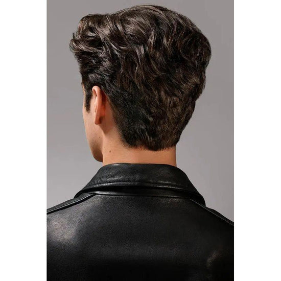 Back of a person's head with voluminous, styled hair wearing a black leather jacket.