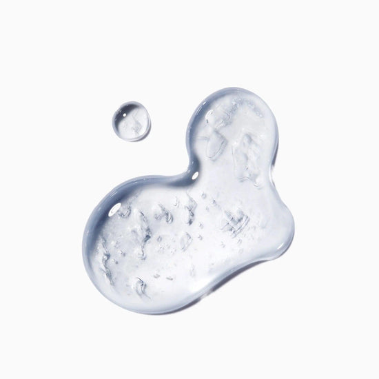 Close-up of Kerastase Genesis Homme Sérum Anti-Chute Fortifiant texture on a white background.