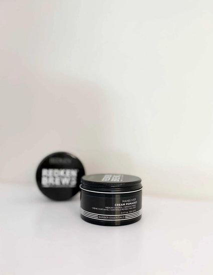 Redken Brews Maneuver Cream Pomade for men's hair, offering flexible hold and natural finish in black jar packaging.