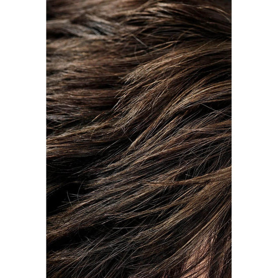 Close-up of tousled brown hair styled with Oribe Rough Luxury Soft Molding Paste for a matte finish and defined texture.