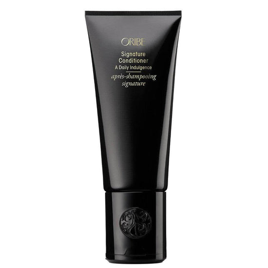 Oribe Signature Conditioner in black tube, hydrating formula for all hair types. Rejuvenates, detangles, and enhances natural shine.